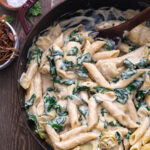 vegan spinach artichoke pasta with crispy fried shallots
