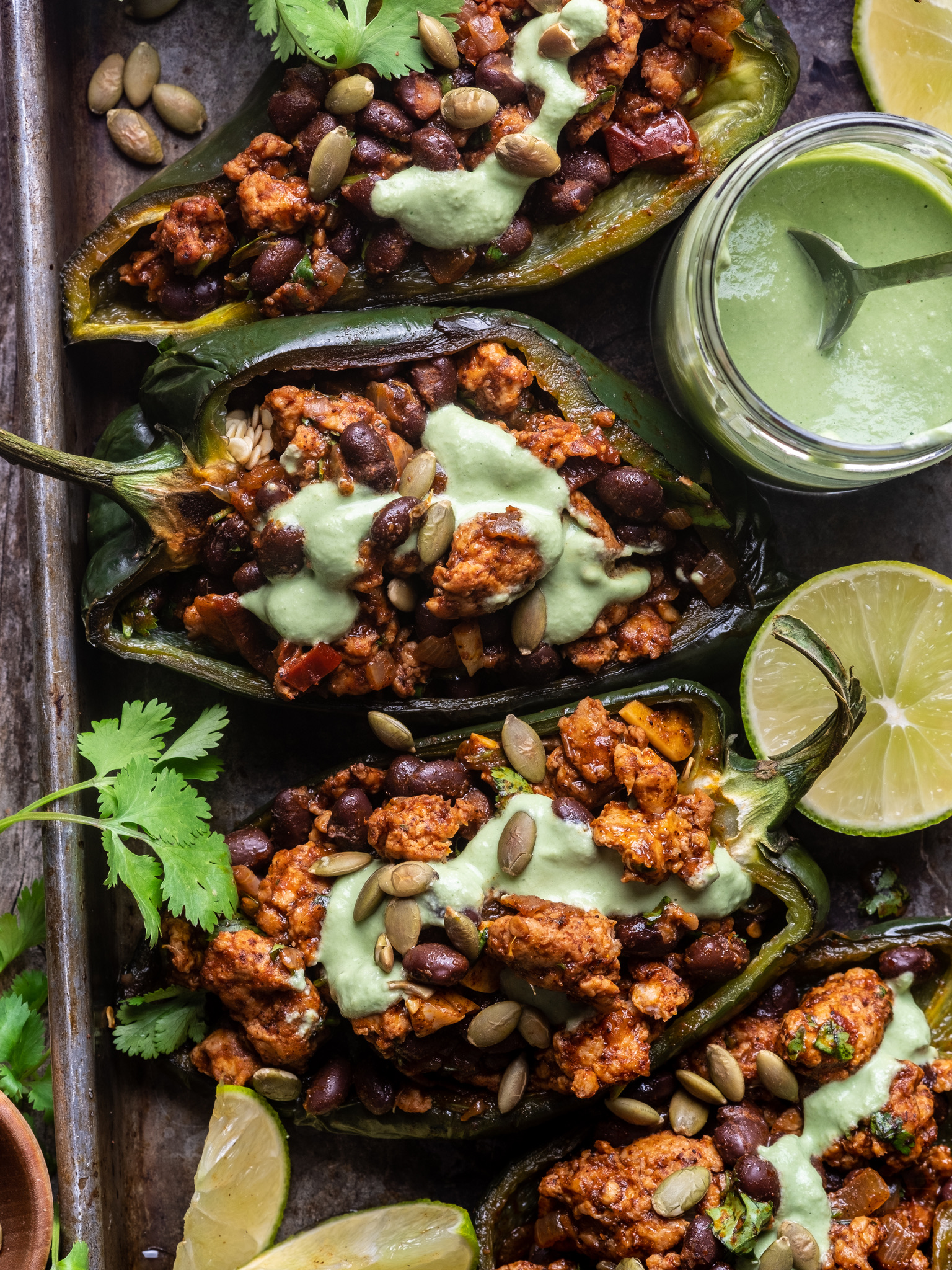 Chipotle Chicken Stuffed Poblano Peppers with Pumpkin Seed Crema